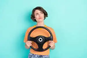 Woman with wheel looking confused