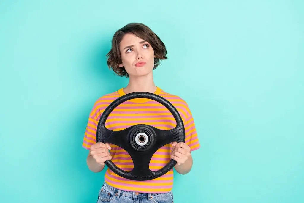 Woman with wheel looking confused